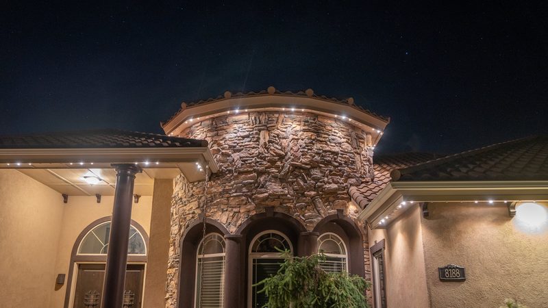 Landscape bed lighting on a stone home