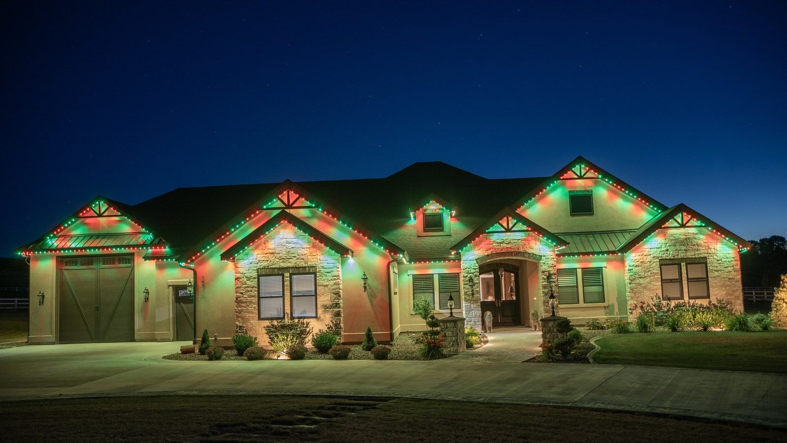 A roofline lit in red, green and white for Christmas