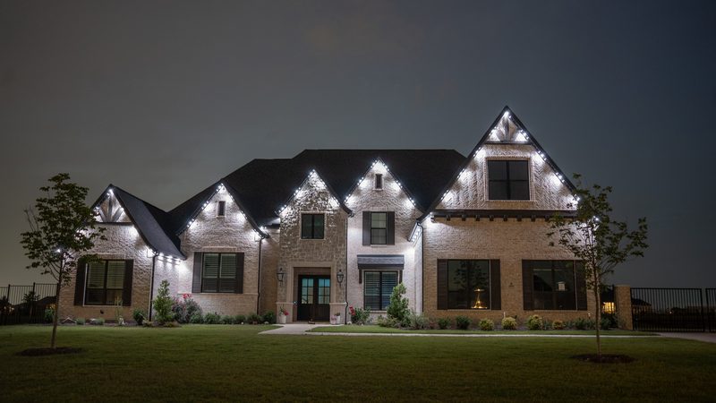 A two-story home lit in cool white