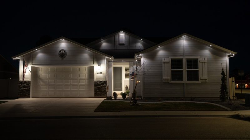 A two-story home lit in warm white